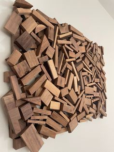 a pile of wooden blocks sitting on top of a white wall