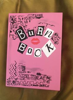 a pink book with the words burn book written in black and white on it's cover