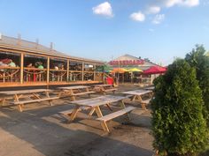 several picnic tables in front of a restaurant