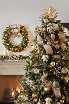 a decorated christmas tree in front of a fireplace