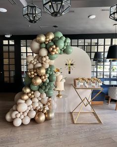 balloons are arranged in the shape of a tree on display at a wedding or birthday party