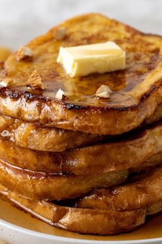 a stack of pancakes with butter on top