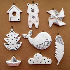 ceramic ornaments are arranged on a brown surface, including one bear and two other birds