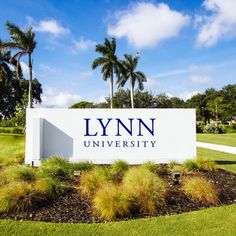 the sign for lynn university in front of palm trees