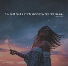 a woman holding a sparkler in her hand with the words you don't need a lover to remind you how rare you are