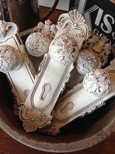 an ornate wooden bowl filled with decorative objects