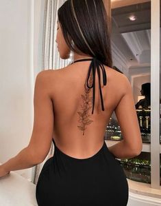 the back of a woman wearing a black dress