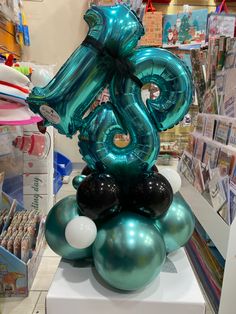 the balloon is shaped like a snake on top of balls