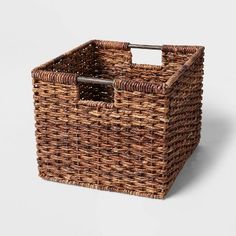 a brown basket with handles on the side and an empty container in the middle for storage