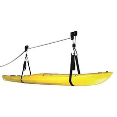 a yellow kayak is hanging from a rope