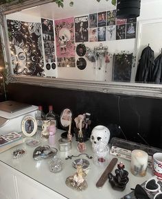 a desk with various items on it and a mirror in the corner behind it,