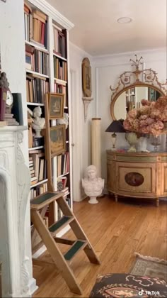 a living room filled with lots of books and furniture