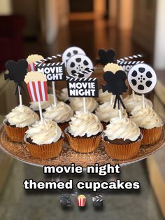 cupcakes with movie themed toppers on a cake plate that says movie night theme cupcakes