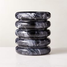 stack of marbled black and white dishes on top of each other