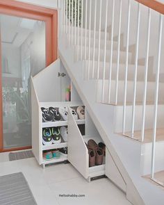 there is a stair case with shoes in the bottom drawer and on the bottom shelf