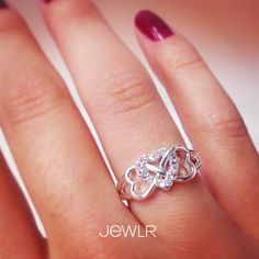 a woman's hand with a ring on it and the words jewellr written in white