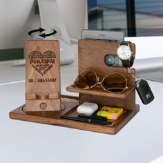 an assortment of personal items are arranged on a desk top with a clock and other accessories