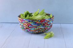 lettuce in a colorful bowl on a white table