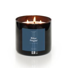 blue sugar candle in a black glass container on a white background with the words blue sugar printed on it