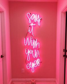 a pink room with neon lights that say it's when your eyes are closed