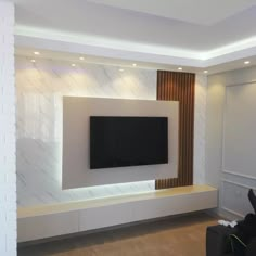 a living room with a flat screen tv mounted on the wall