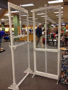 a room divider in the middle of an open area with people walking around it