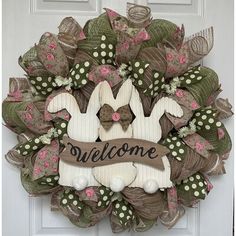 a welcome wreath is hanging on the front door