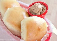 two rolls in a basket with dipping sauce