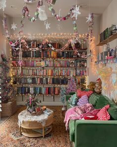 a living room filled with lots of furniture and bookshelves covered in christmas decorations