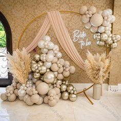 balloons are arranged in the shape of a christmas tree on display at a wedding reception