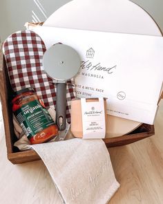 an open wooden box filled with food and condiments on top of a table