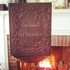 a fireplace with a sign that says grand grimoline on the front and side