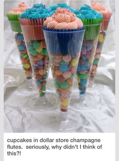 cupcakes with colorful frosting and sprinkles on them are in cups