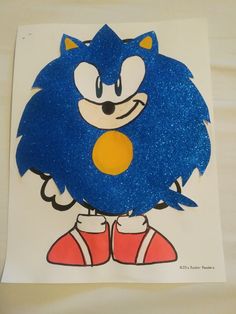 a drawing of sonic the hedgehog on a piece of paper with blue glitter paint