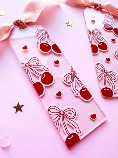 two valentine's day cards with hearts and cherries on them, tied together