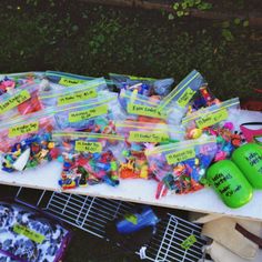 a table topped with lots of plastic bags filled with candy