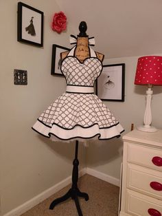 a mannequin is dressed up in a white and black dress