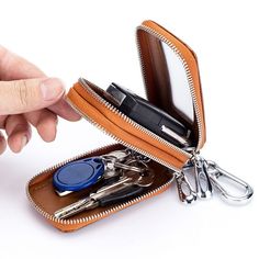 a person is opening an open wallet with scissors and keys in it on a white background