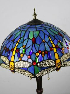 a stained glass lamp with dragonflies on it