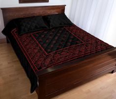 a bed with black and red bedspread on it