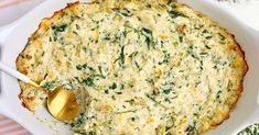 a casserole dish with spinach and cheese in it on a white plate