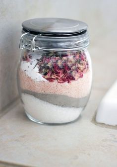 a jar filled with lots of different types of flowers