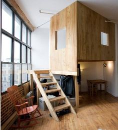 a loft bed is built into the side of a wall with stairs leading up to it