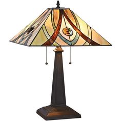 a lamp that is sitting on top of a wooden stand with a glass shade over it