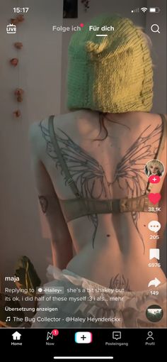 the back of a woman's body with tattoos on it