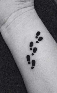 a black and white photo of a person's foot with the word tattoo on it