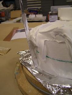 a cake is wrapped in aluminum foil and ready to be cut