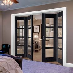 a bedroom with double doors leading to another room