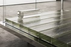 a glass table sitting on top of a cement floor