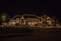 a large house covered in christmas lights at night